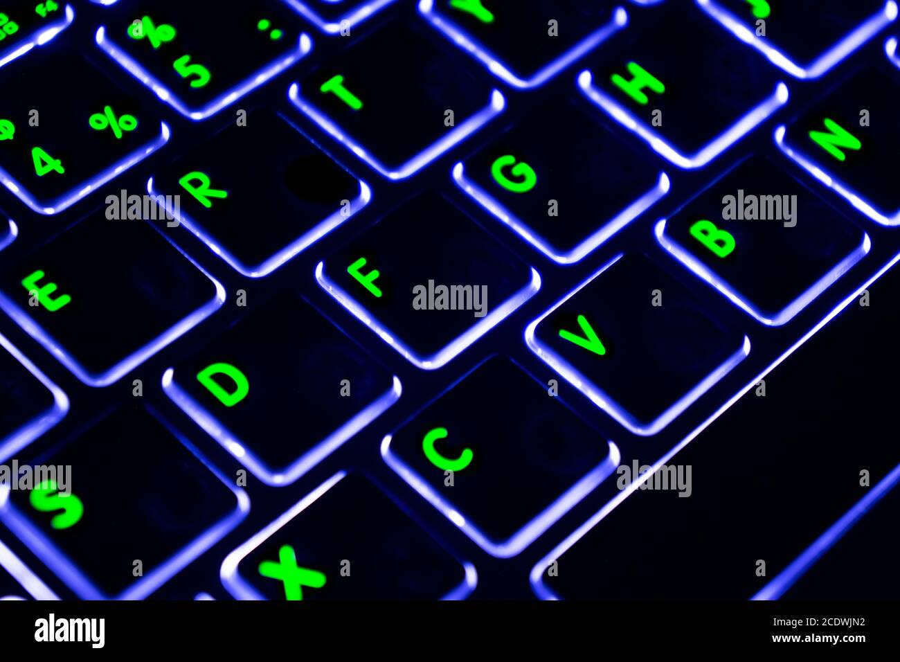 Close up view of a modern laptop computer keyboard key with blue buttonss. Pc computer keyboard close up Stock Photo