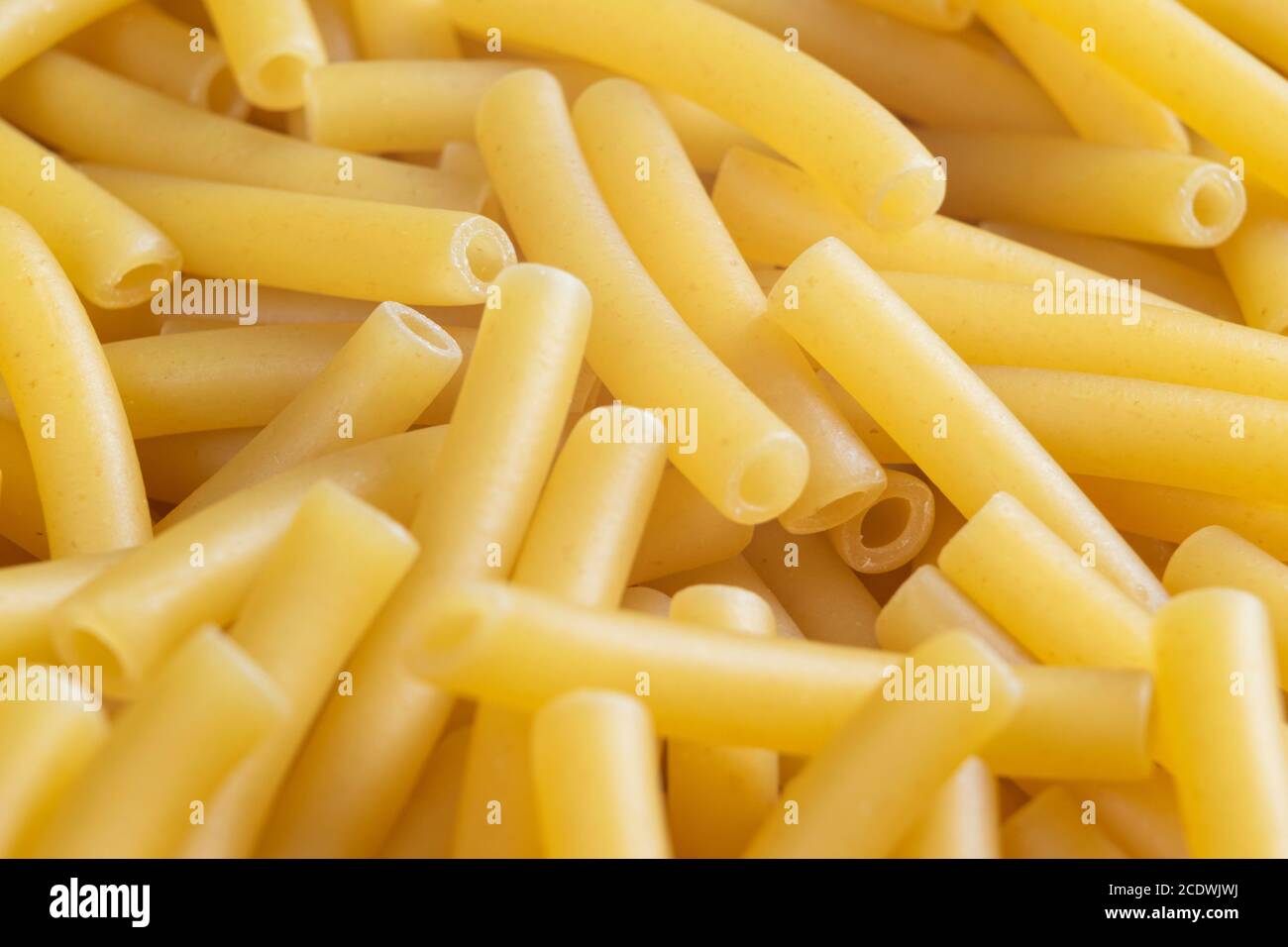 Macro shot pasta noodles texture. Macaroni background pattern. Top view. Dry pasta for cooking. Abstract italian macaroni background Stock Photo