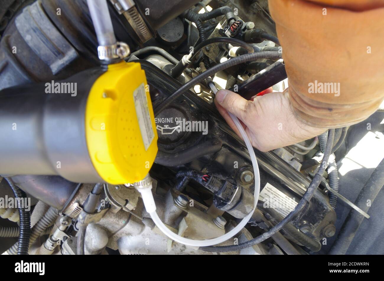 Mechanic changing through the dipstick pump - Alamy