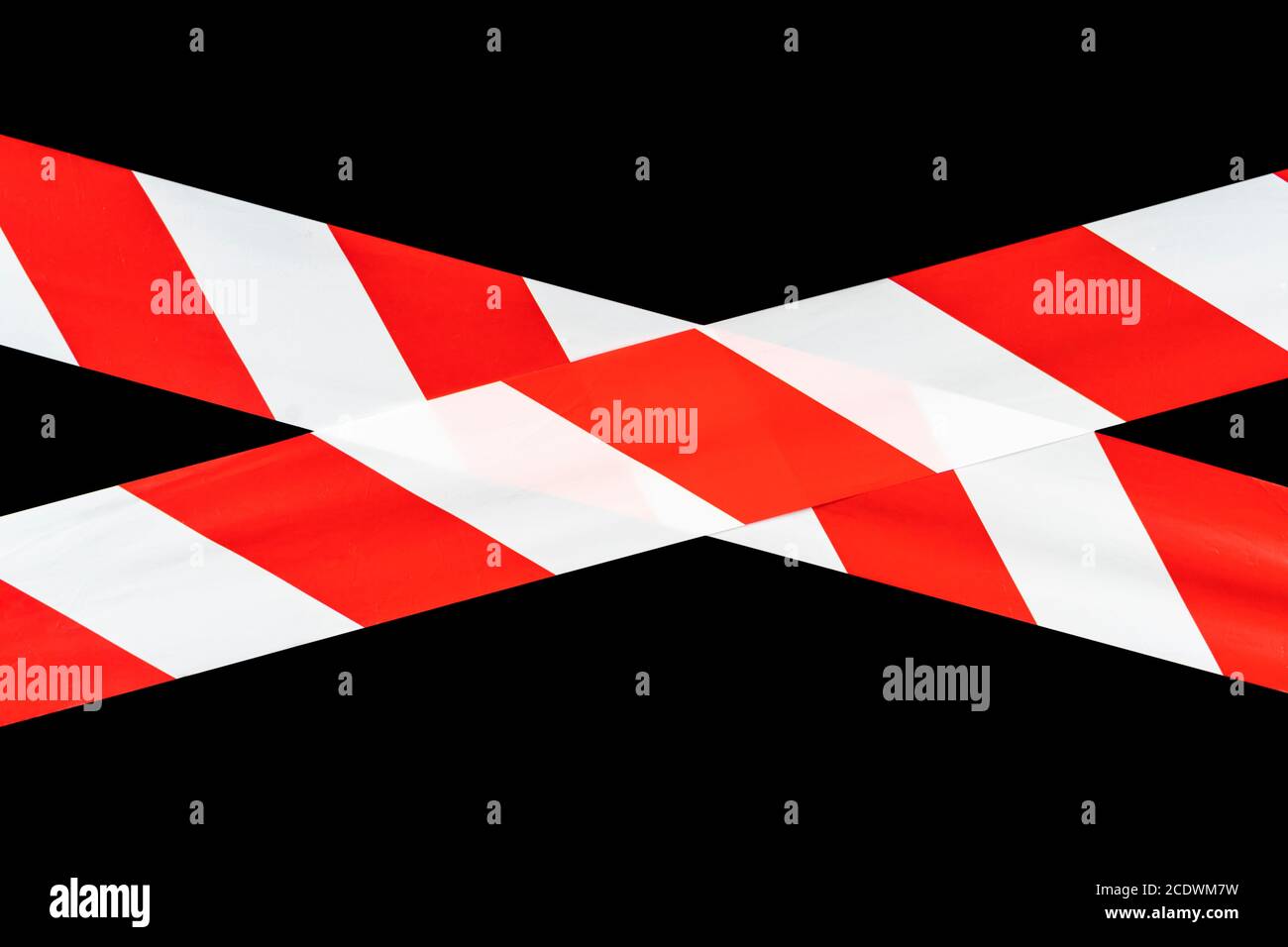Red and white warning caution tape isolated on black background with clipping path. Red and white lines of barrier tape. Protects for no entry isolate Stock Photo