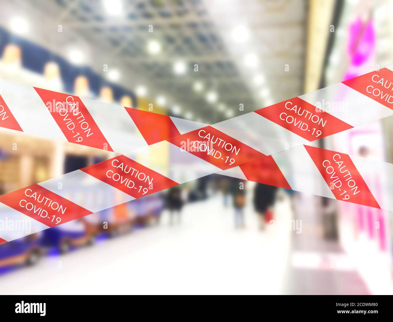 Red and white warning caution tape covid19 warning in shopping mall