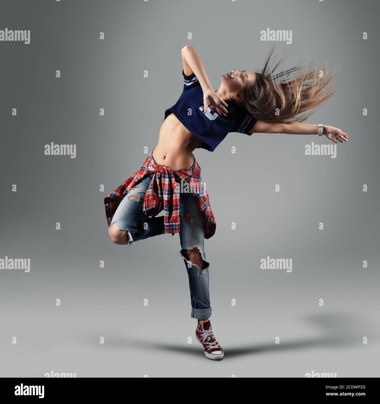 modern young beautiful dancer posing on a studio background Stock Photo