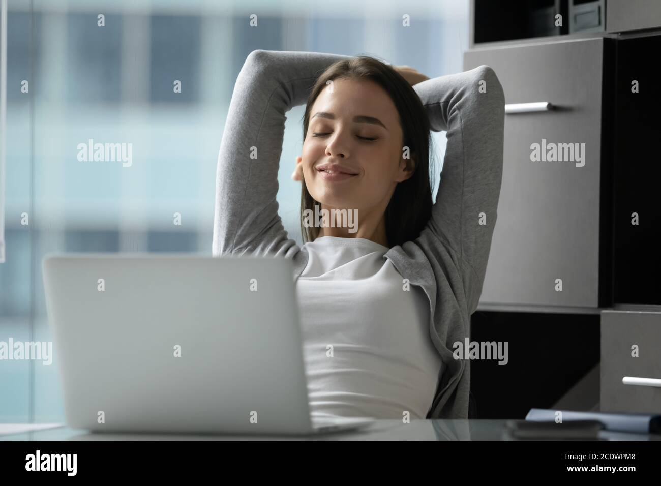 Woman leaning back in chair hi-res stock photography and images - Alamy