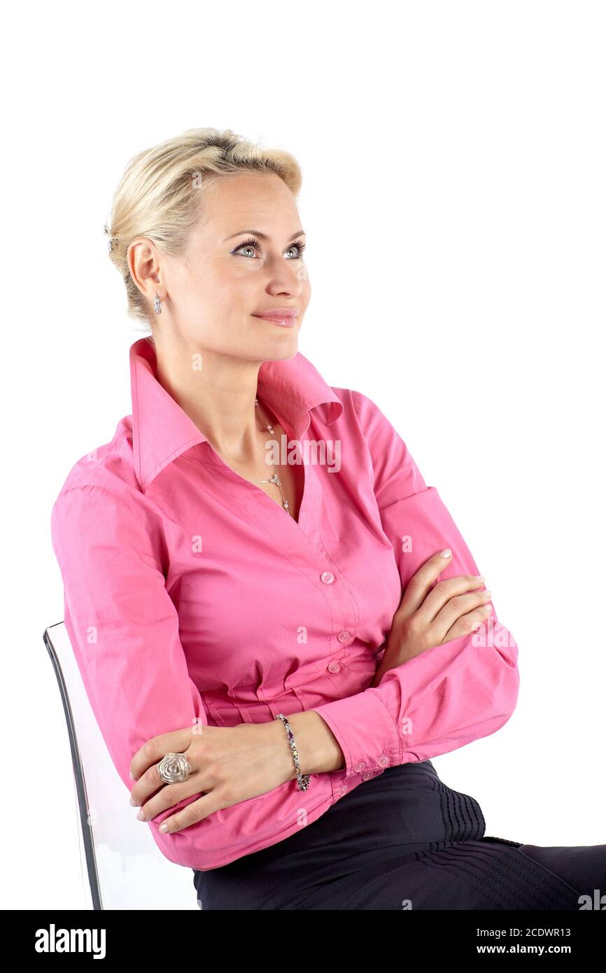Portrait of a businesswoman sitting three-quarters on a chair and looking up, isolated on white background Stock Photo