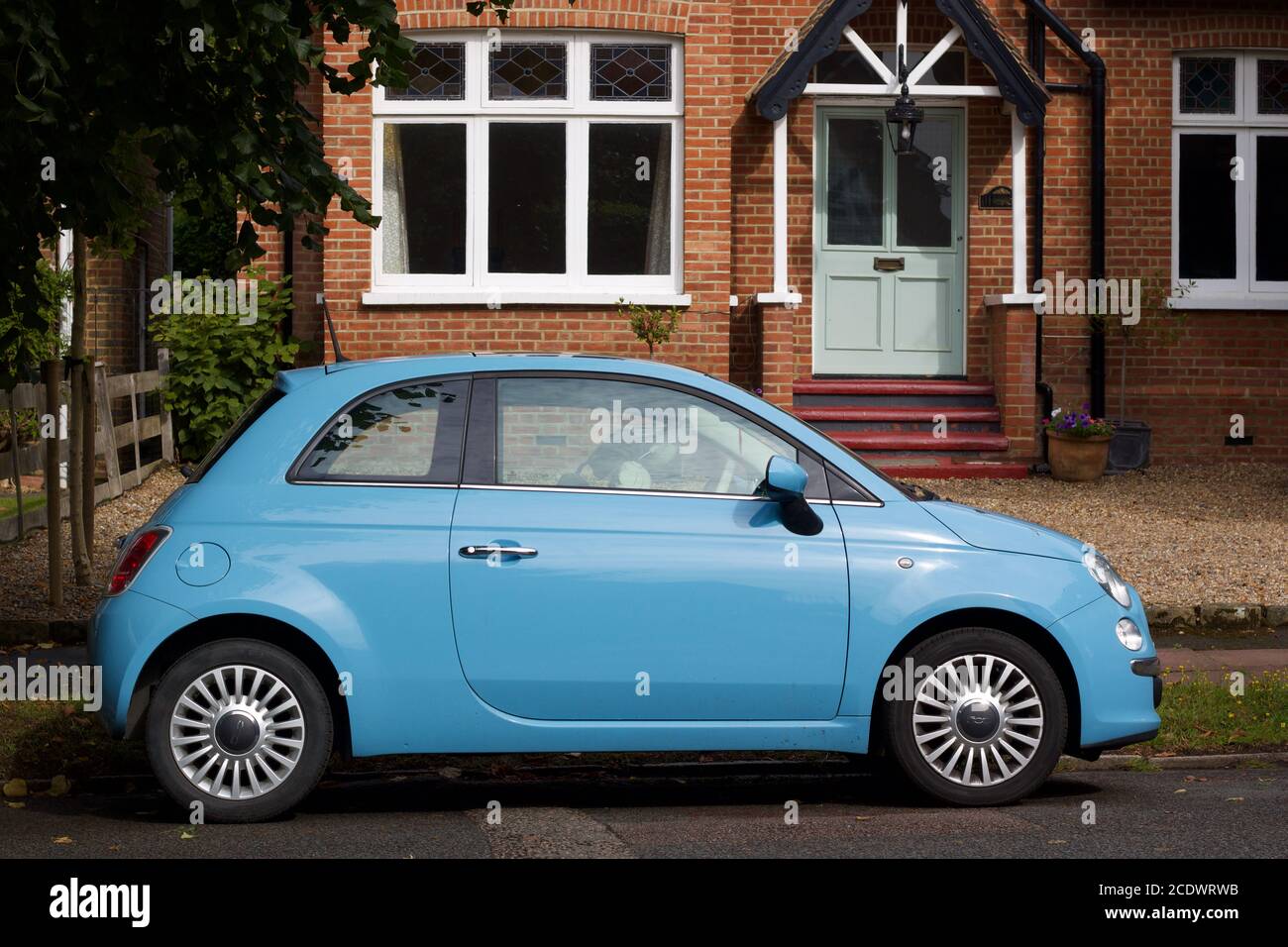 16 August 2020 - England, UK: Blue Fiat 500 outside old Victorian house Stock Photo