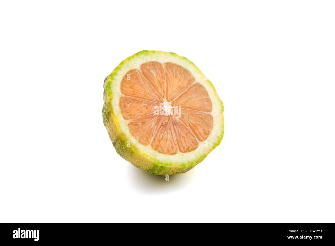 Lemon cut in half with pink flesh isolated on white background. The variegated pink lemon or pink-fleshed Eureka lemon, green-striped rind Stock Photo