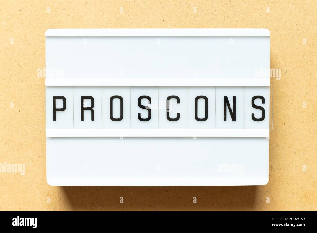 Lightbox with word pros cons on wood background Stock Photo