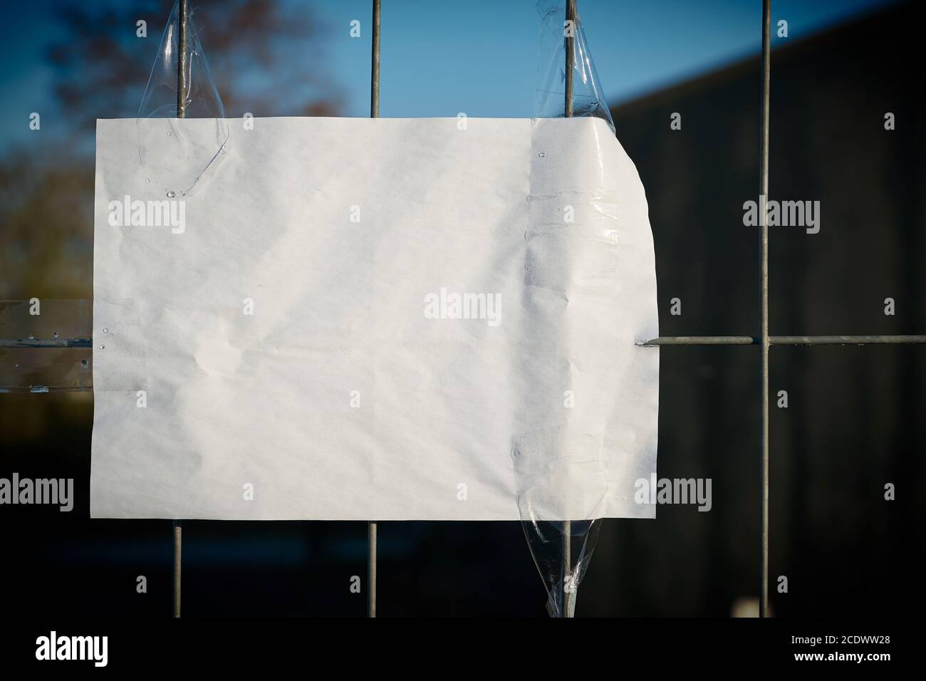 Sheet of paper with copy space on a fence Stock Photo