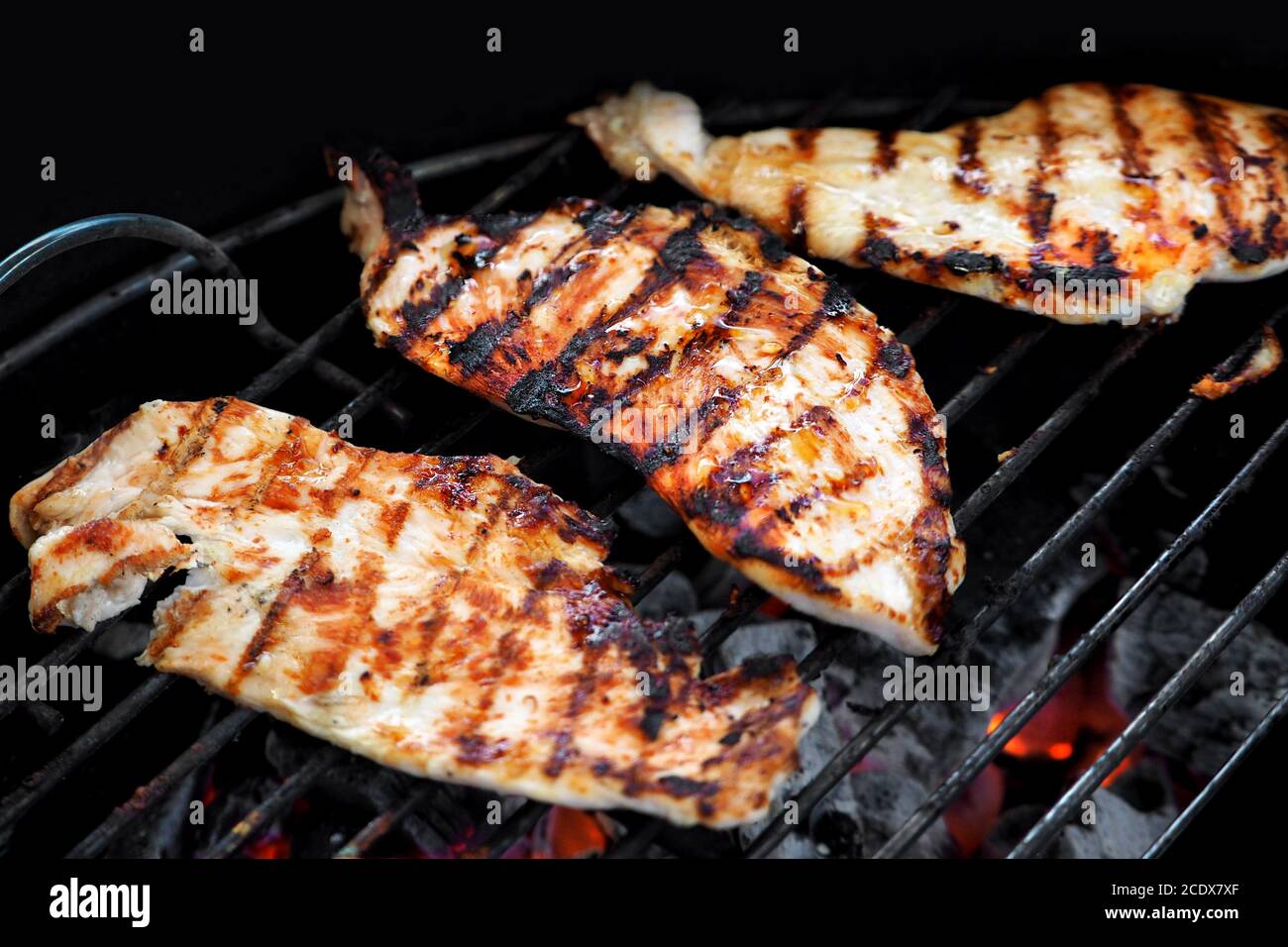 Chicken fillet fried on the grill. Macro shot. Blurred background. Stock Photo