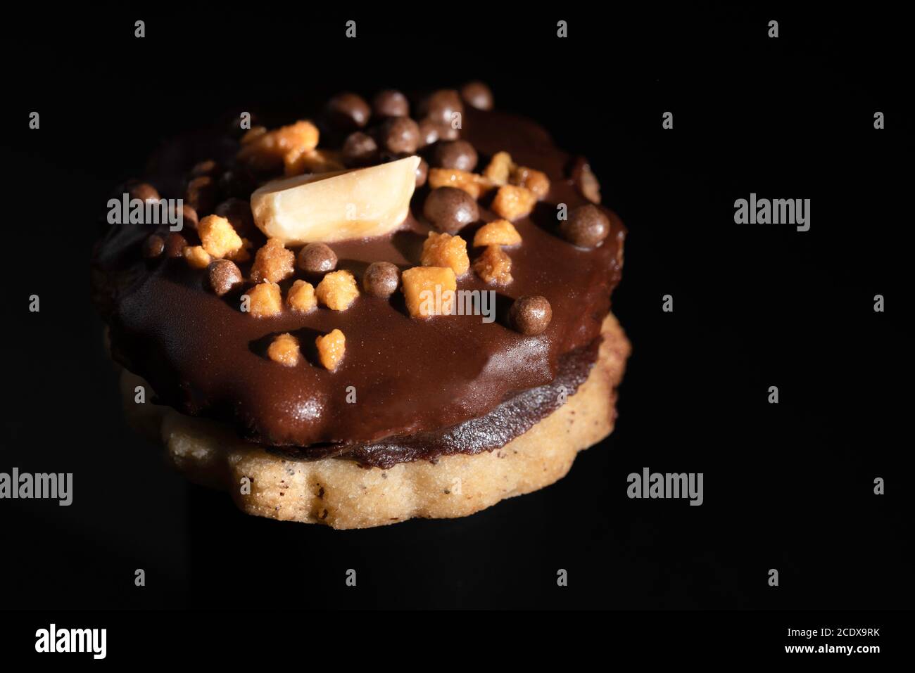 Brown Isler (or Ischler, Ishler) Cookies with hazelnuts and peanut brittle on brown background, dating back to Austro-Hungarian Empire Stock Photo