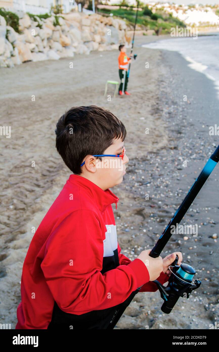 photography of boy fishing on the beach in high quality Stock Photo Alamy