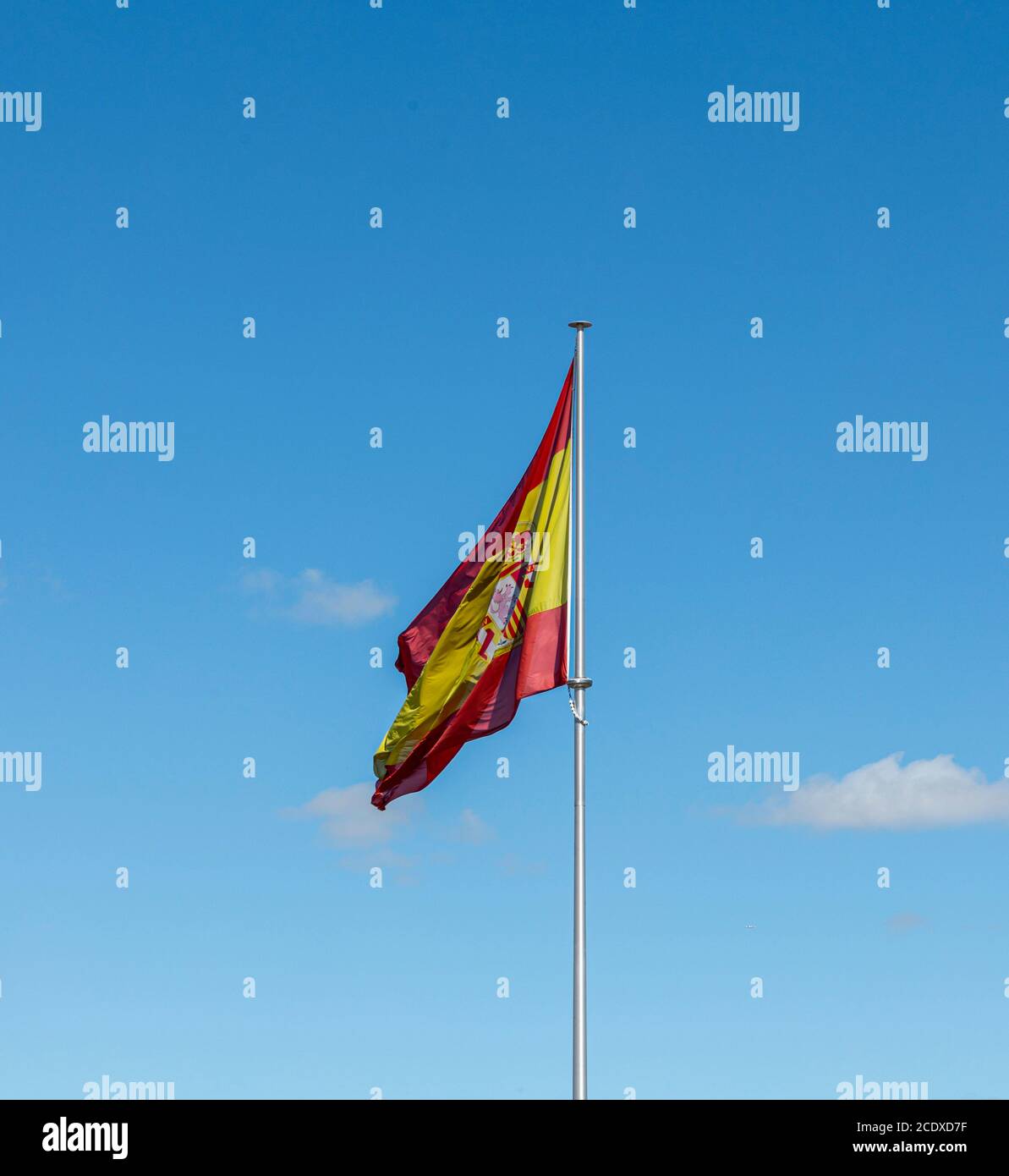 Spanish flag over a blue sky Stock Photo