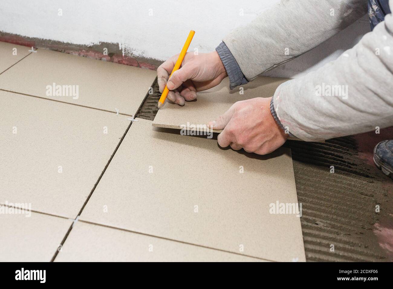 Installing ceramic floor tile hires stock photography and images Alamy