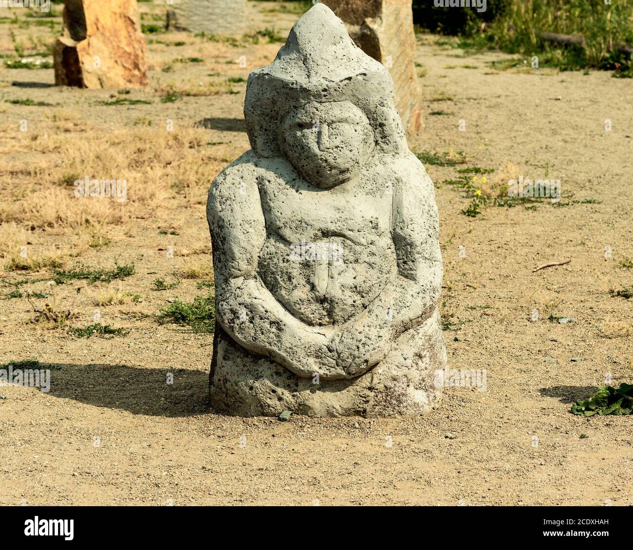 A stone anthropomorphic statue in a clearing. Stock Photo