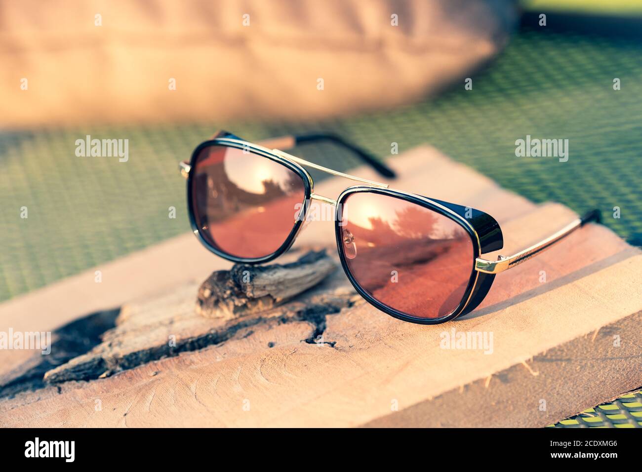 Retro sunglasses model with red lenses shoot in a summer day closeup. Selective focus Stock Photo
