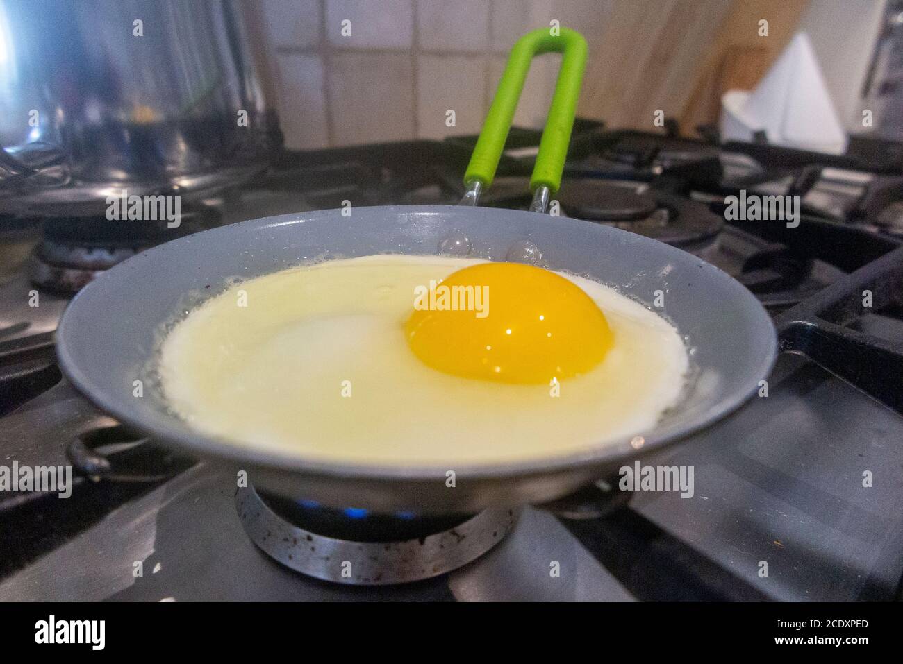 A single egg fries in a small frying pan Stock Photo Alamy