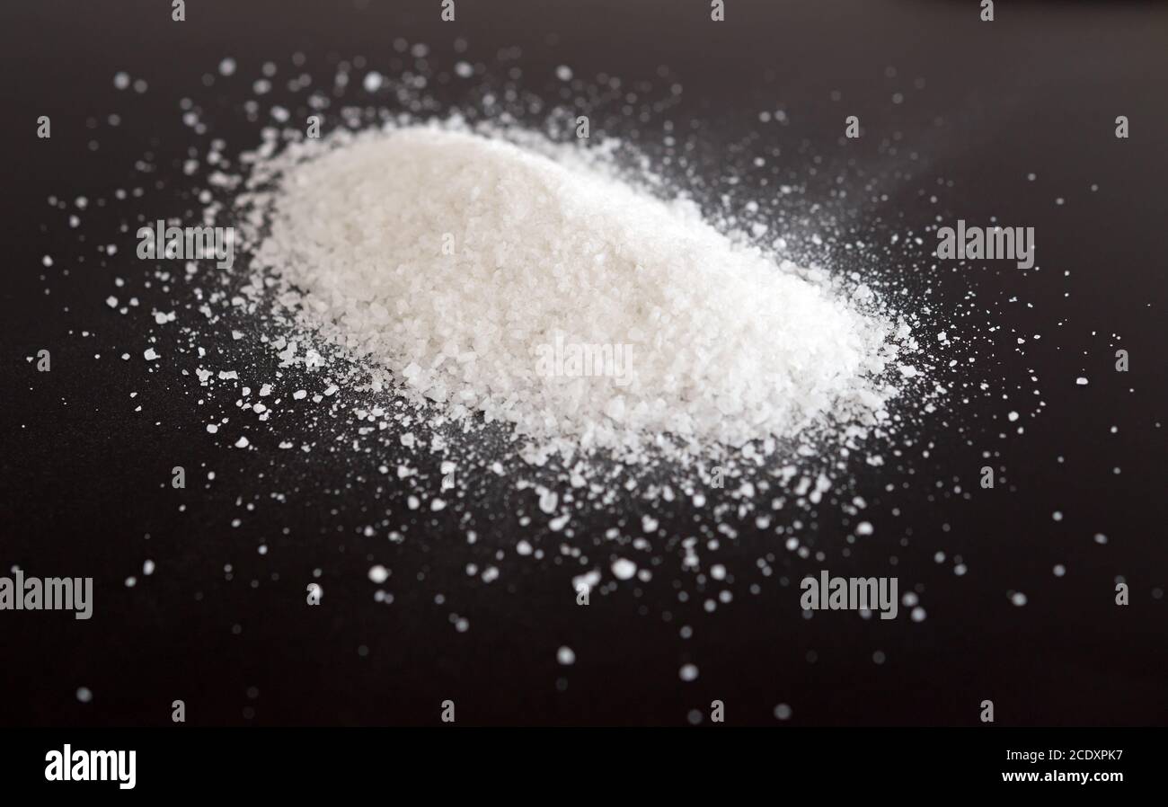 Salt on black Stock Photo
