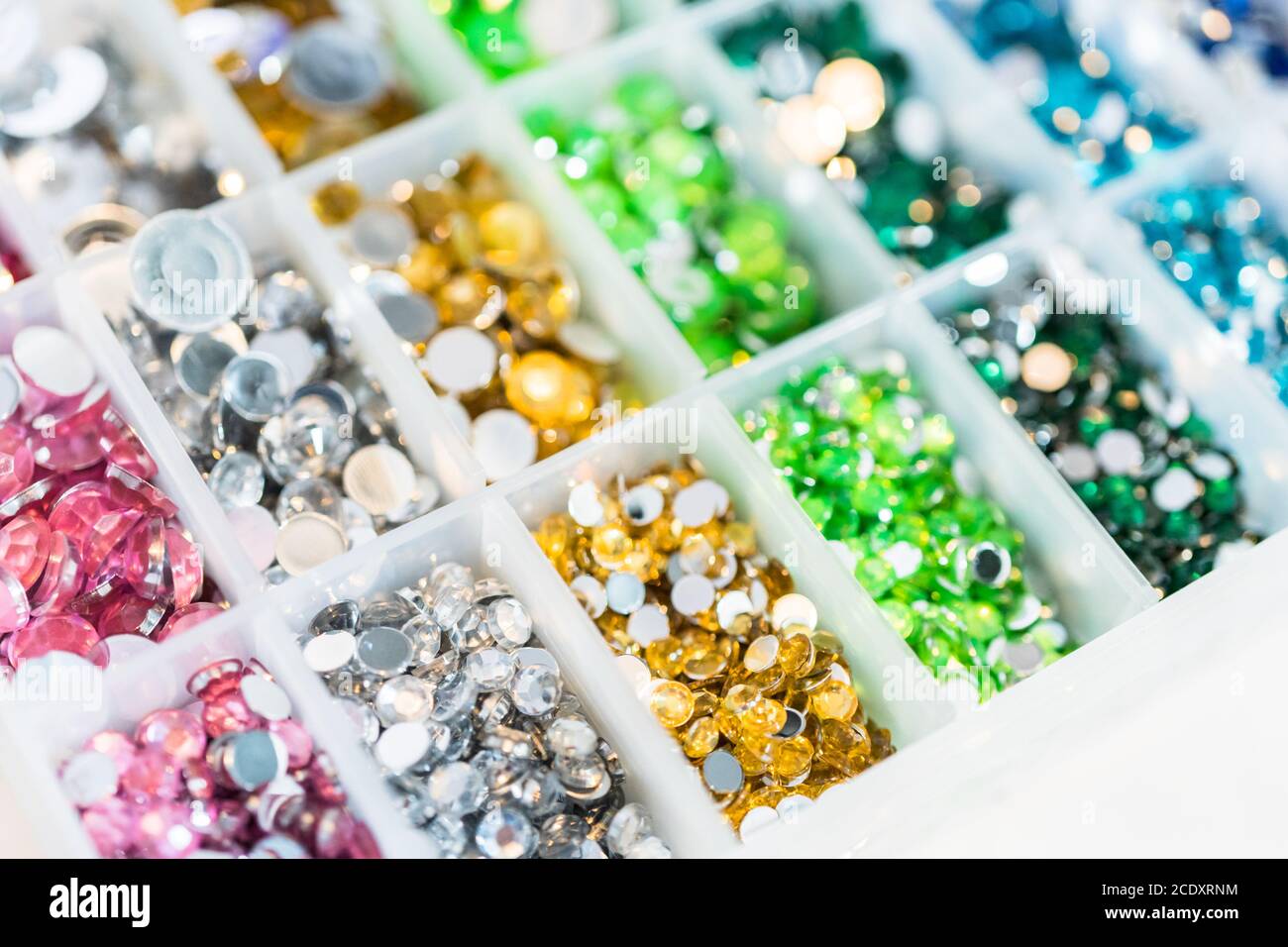Comparing Craft Rhinestones Color and size variety of rhinestones in the craft box Stock Photo - Alamy