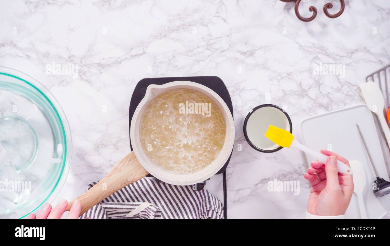 Flat lay. Step by step. Caramelizing sugar in a small cooking pot over ...