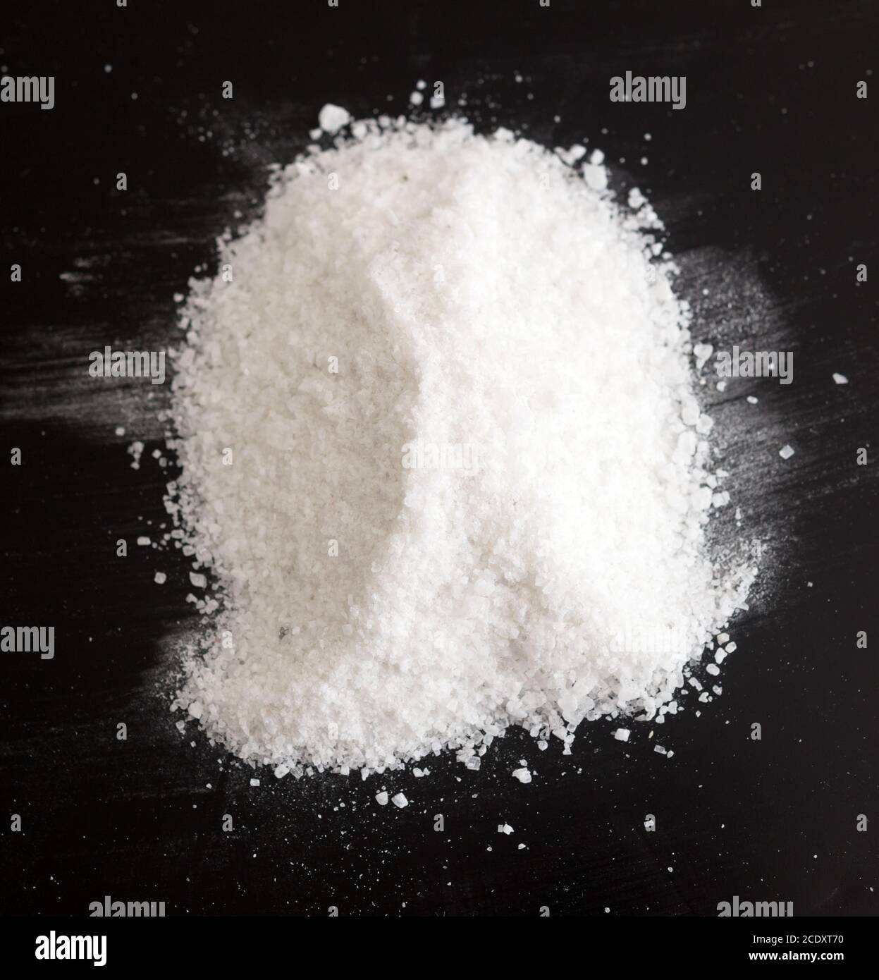 Salt on black Stock Photo