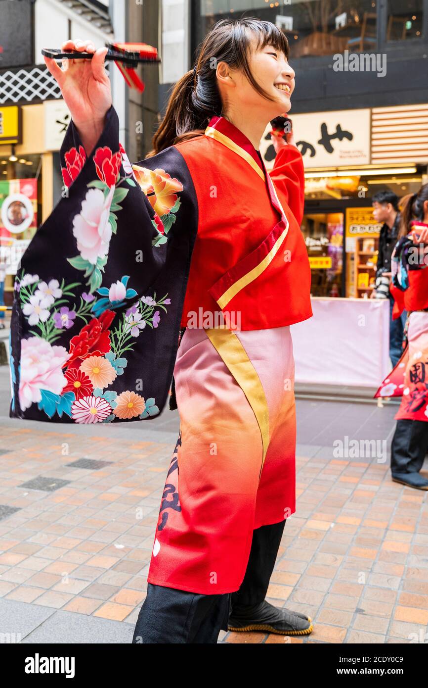 Close up of a pretty Japanese women, part of a yosakoi dance team, dancing while holding naruko, during the Kyusyu Gassai festival at Kumamoto in Japa Stock Photo