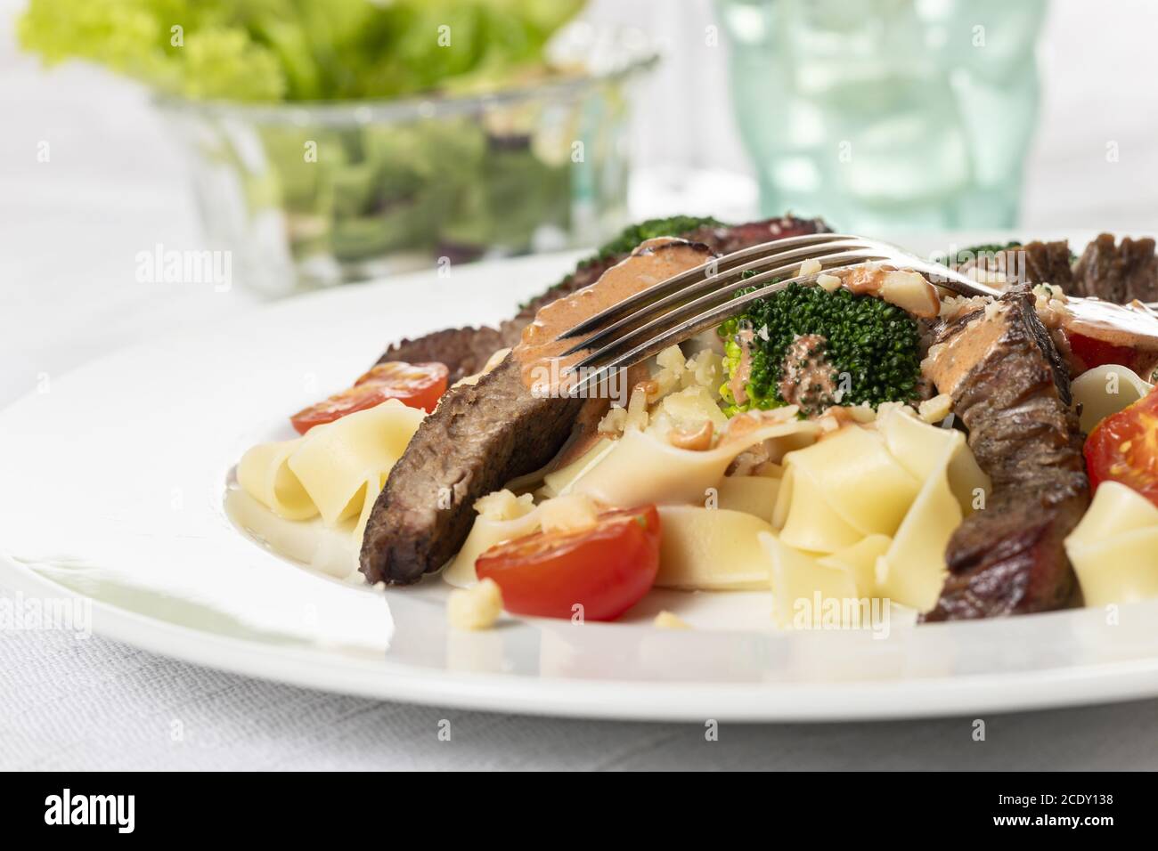 Tagliatelli with steak slices on the plate Stock Photo