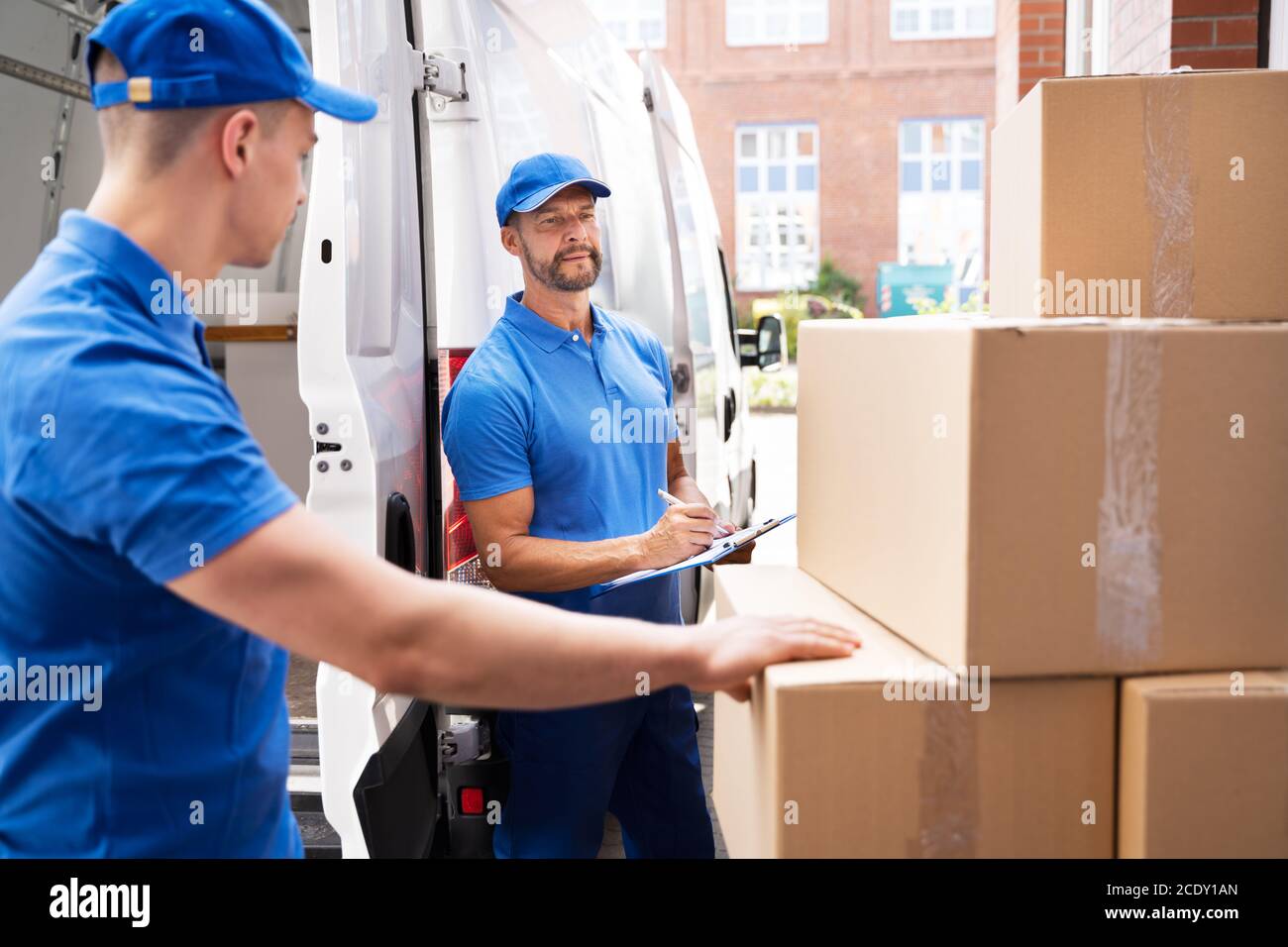 Van Courier And Professional Movers Unload Truck Stock Photo Alamy