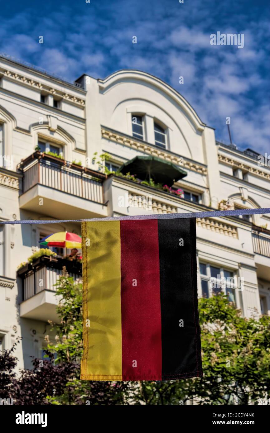 Germany flag with renovated old building in background in Berlin, Germany Stock Photo