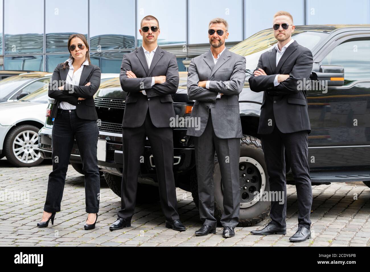 Business Security Guard Service At Work Near Luxury Car Stock Photo