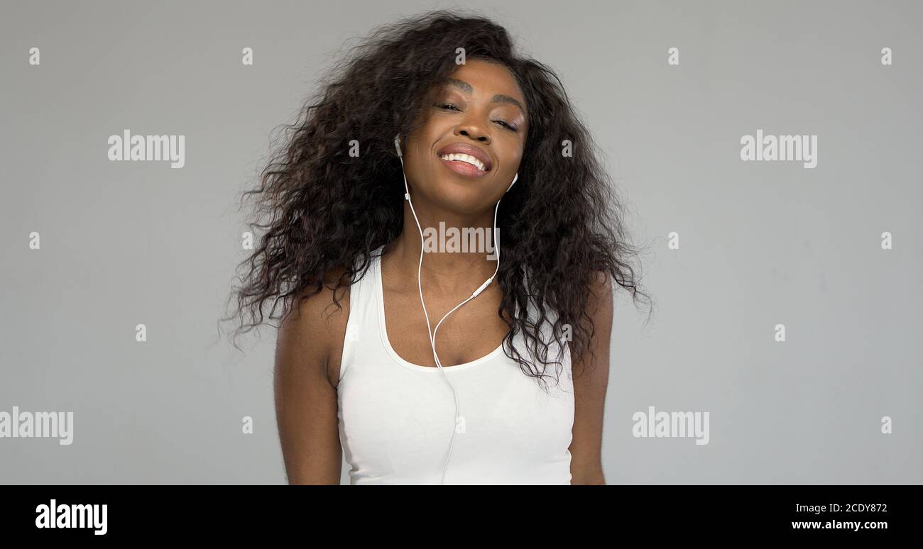 African woman smiling listening hi-res stock photography and images - Alamy