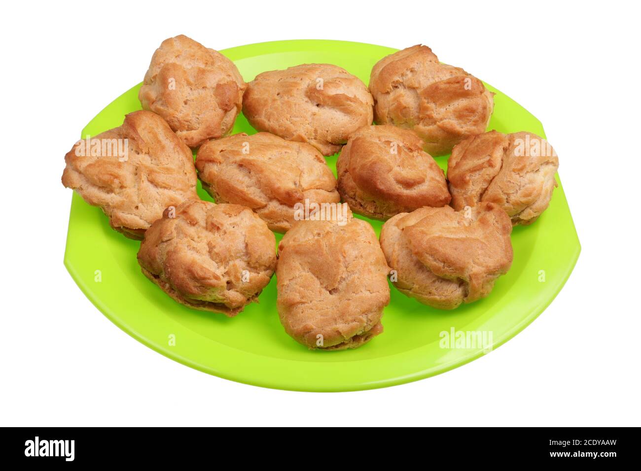 Homemade soft sweet eclairs pastries on a green plate isolated Stock Photo