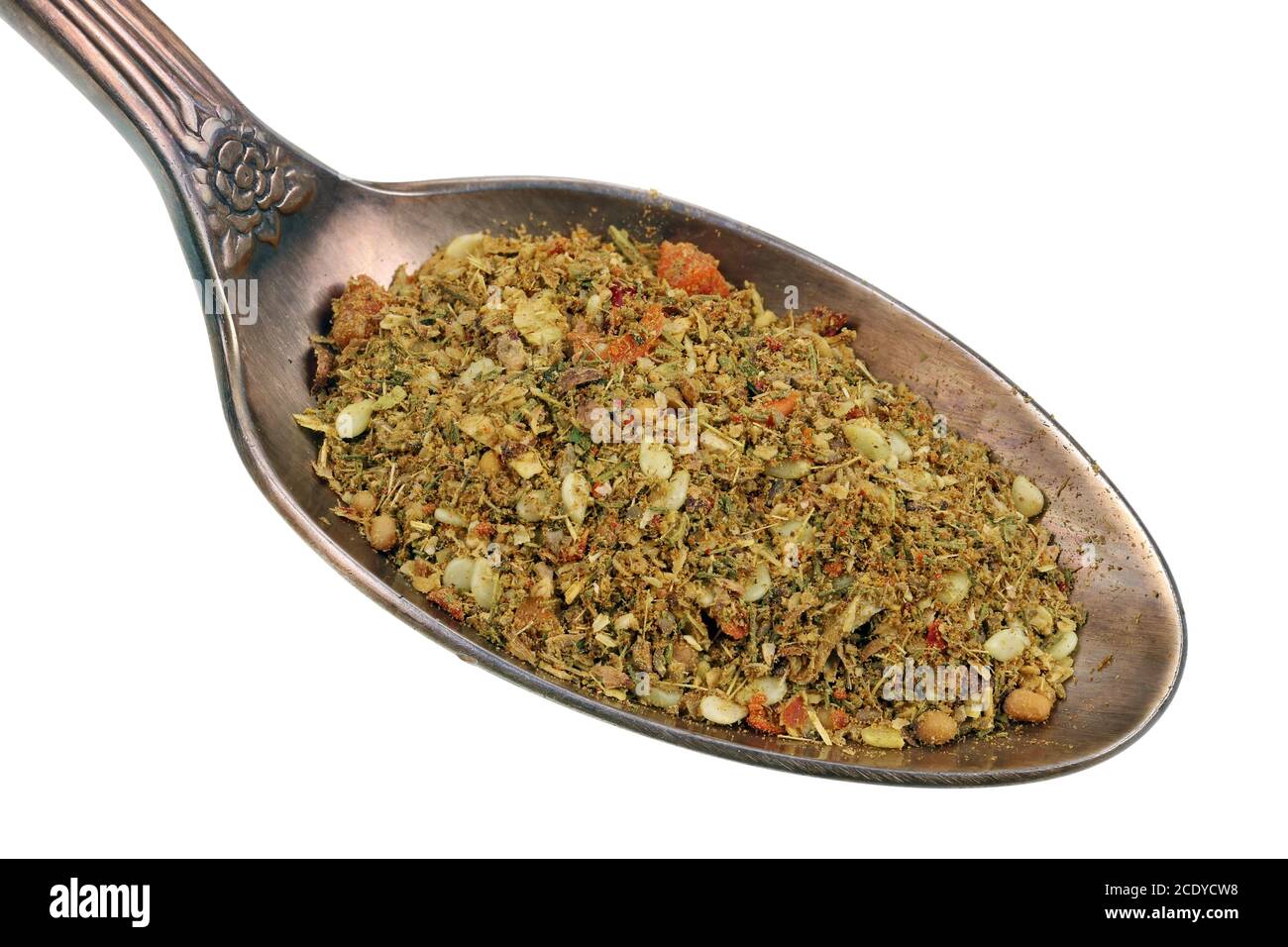 In the old golden spoon there is a small pile of food -  dried  herb spices for salmon fish  isolated macro Stock Photo