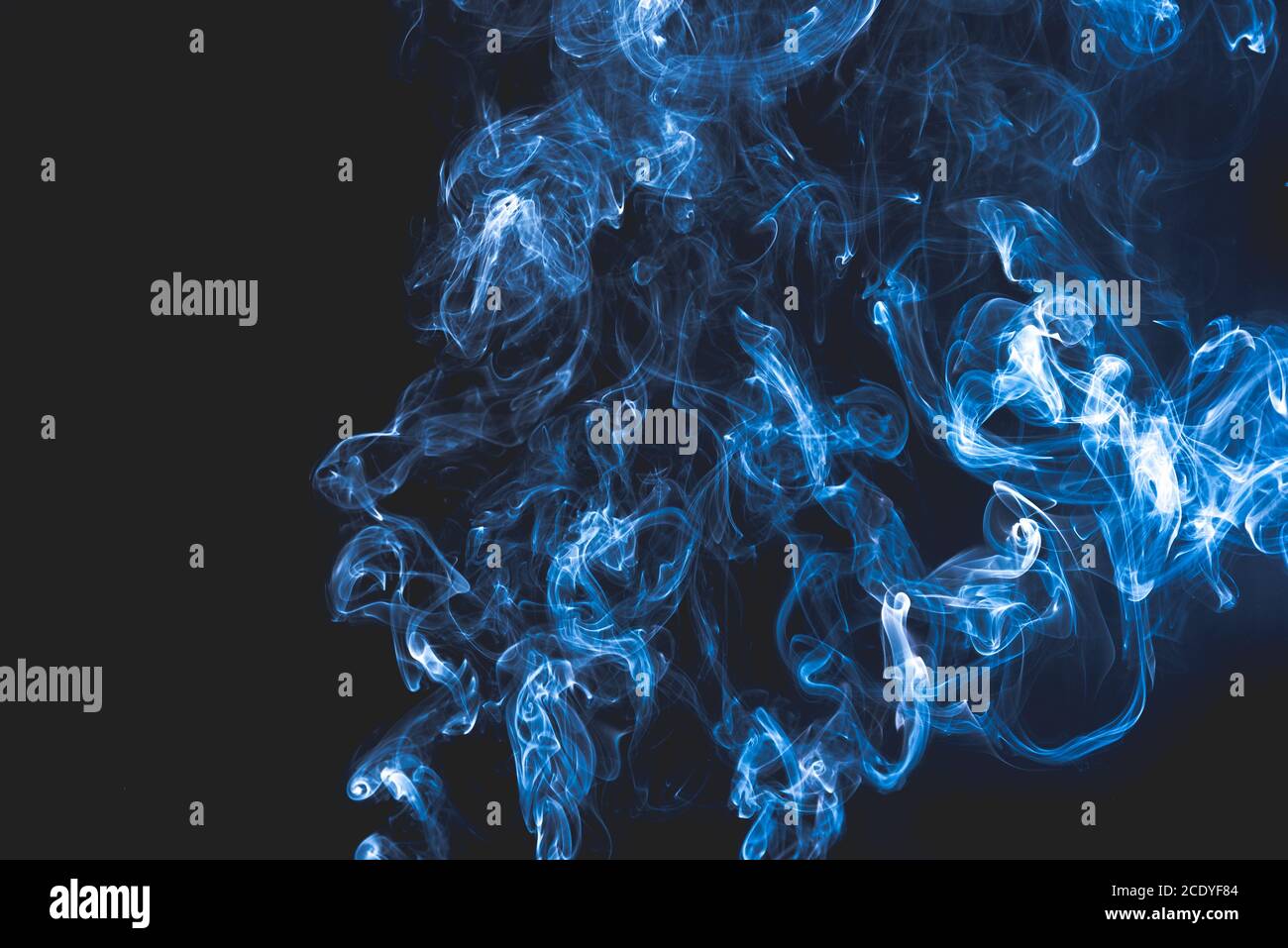 Blue abstract shaped smoke against black background Stock Photo - Alamy