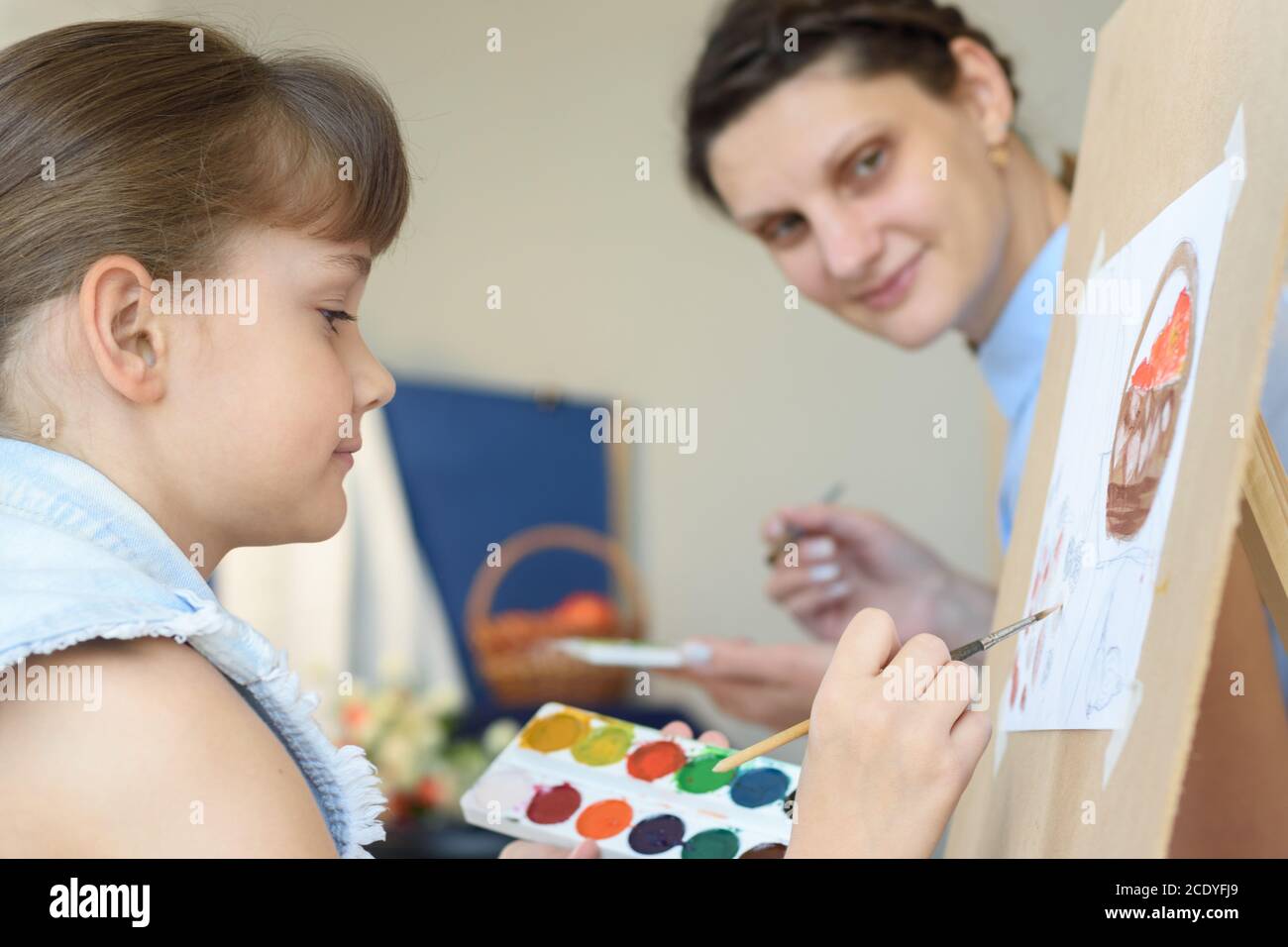 Teacher looks at how a student draws still life Stock Photo