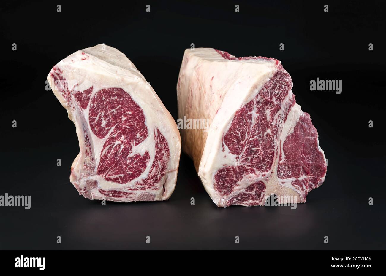 Raw dry aged wagyu porterhouse and cote de boeuf beef block as closeup