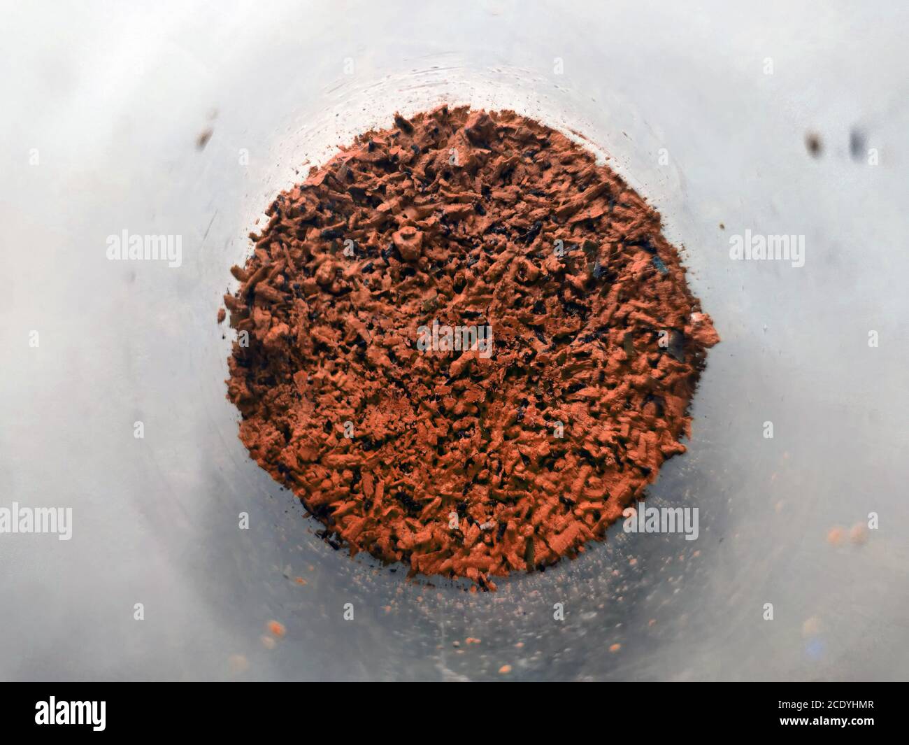 Orange Round Container Powder Orange powder in glass cup, bowl with ingredient close up. colored ...