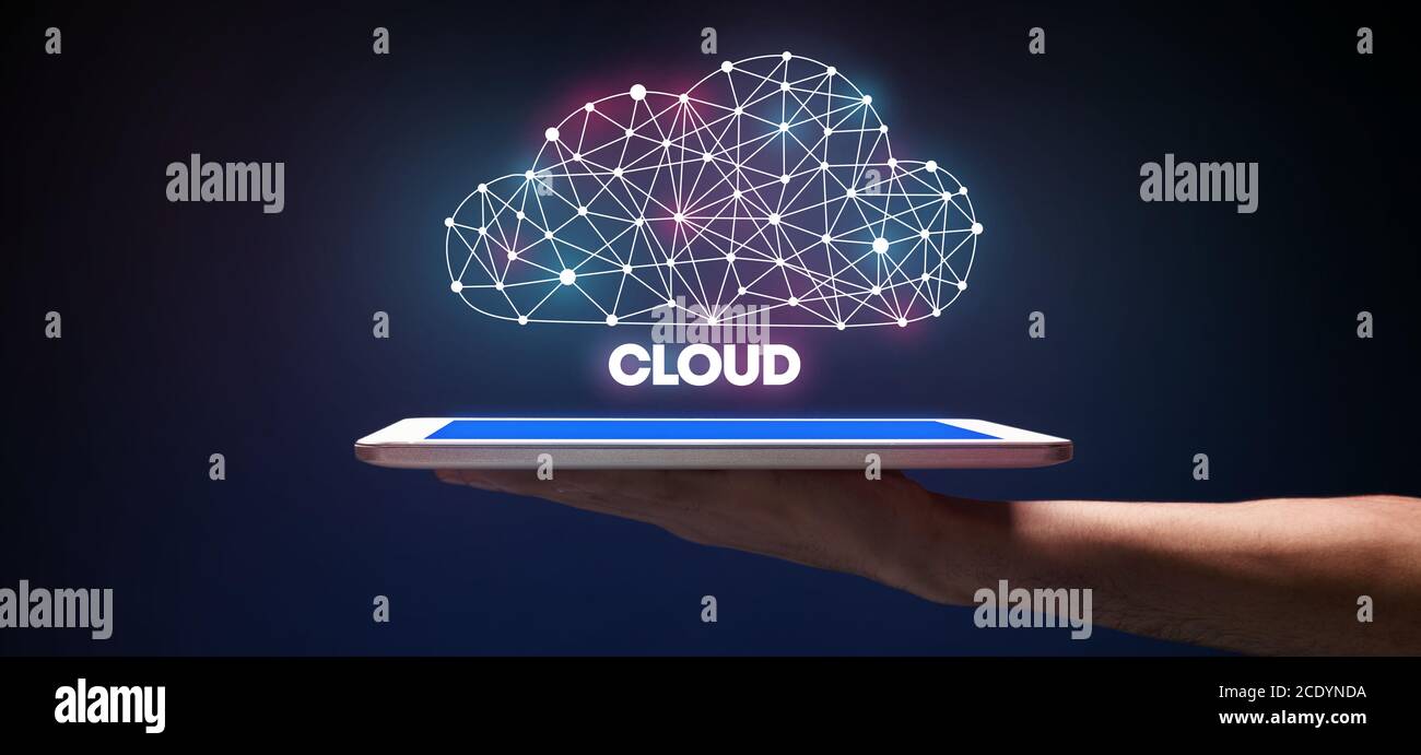 Cloud Data Storage Technology. Man Holding Digital Tablet With Polygonal Cloud Hologram Stock Photo