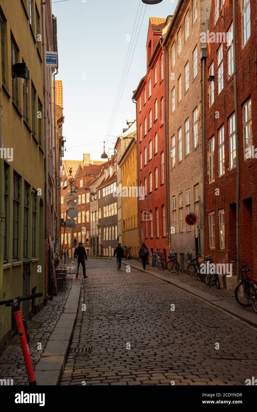 Classic narrow street with colorful rowhomes in Copenhagen (DK) Stock Photo