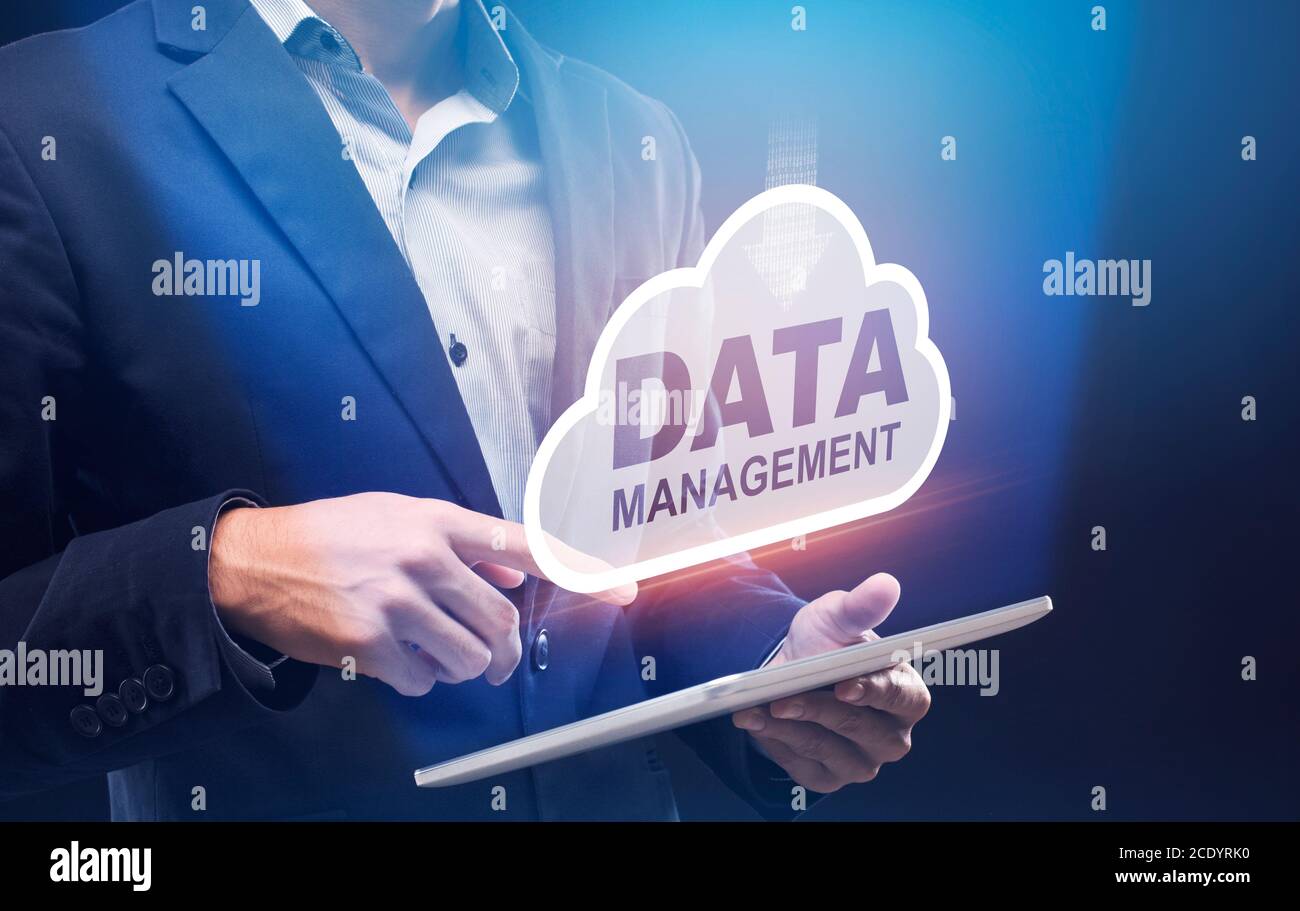 Business Data Management. Businessman Holding Digital Tablet With Storage Cloud Hologram Above Stock Photo