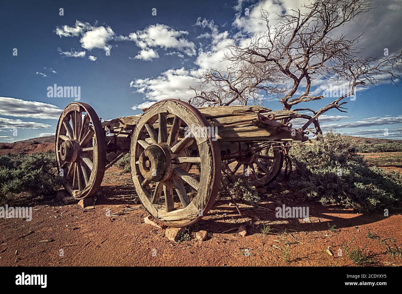 Australia  Outback savanna with an old vintage derelict horse-drawn carriage at the bush under blue sky Stock Photo