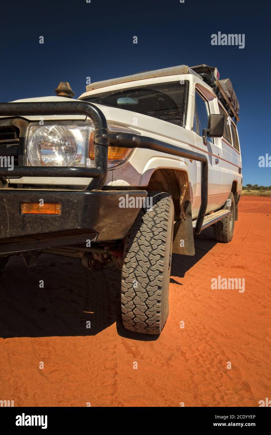 Western Australia Outback track with 4WD car on red sand at the ocean at Dampier Peninsula