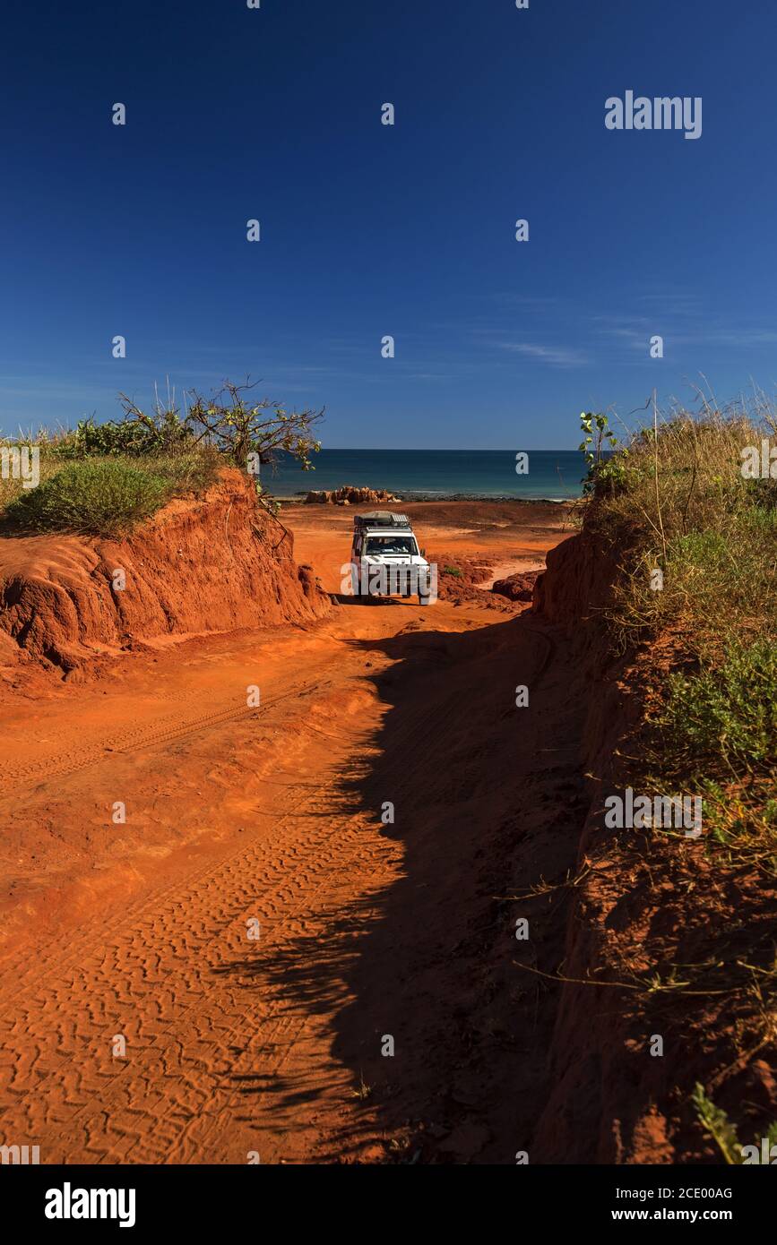 Western Australia Outback track with 4WD car going uphill from the ocean at Dampier Peninsula