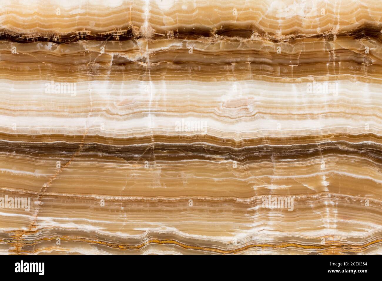 Beige patterned onyx close-up, natural stone backgorund. Stock Photo