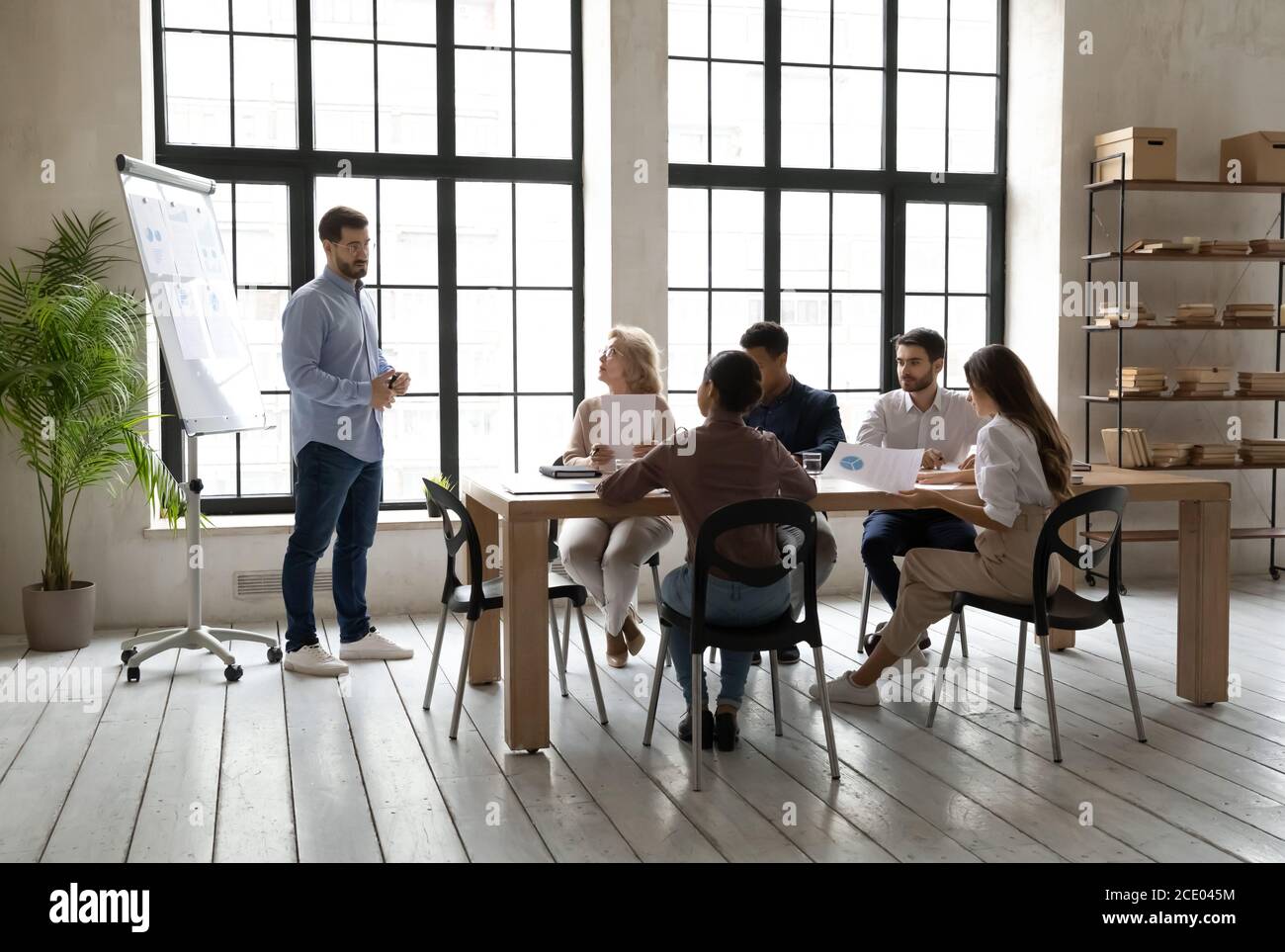 Skilled young speaker presenting corporate marketing strategy. Stock Photo