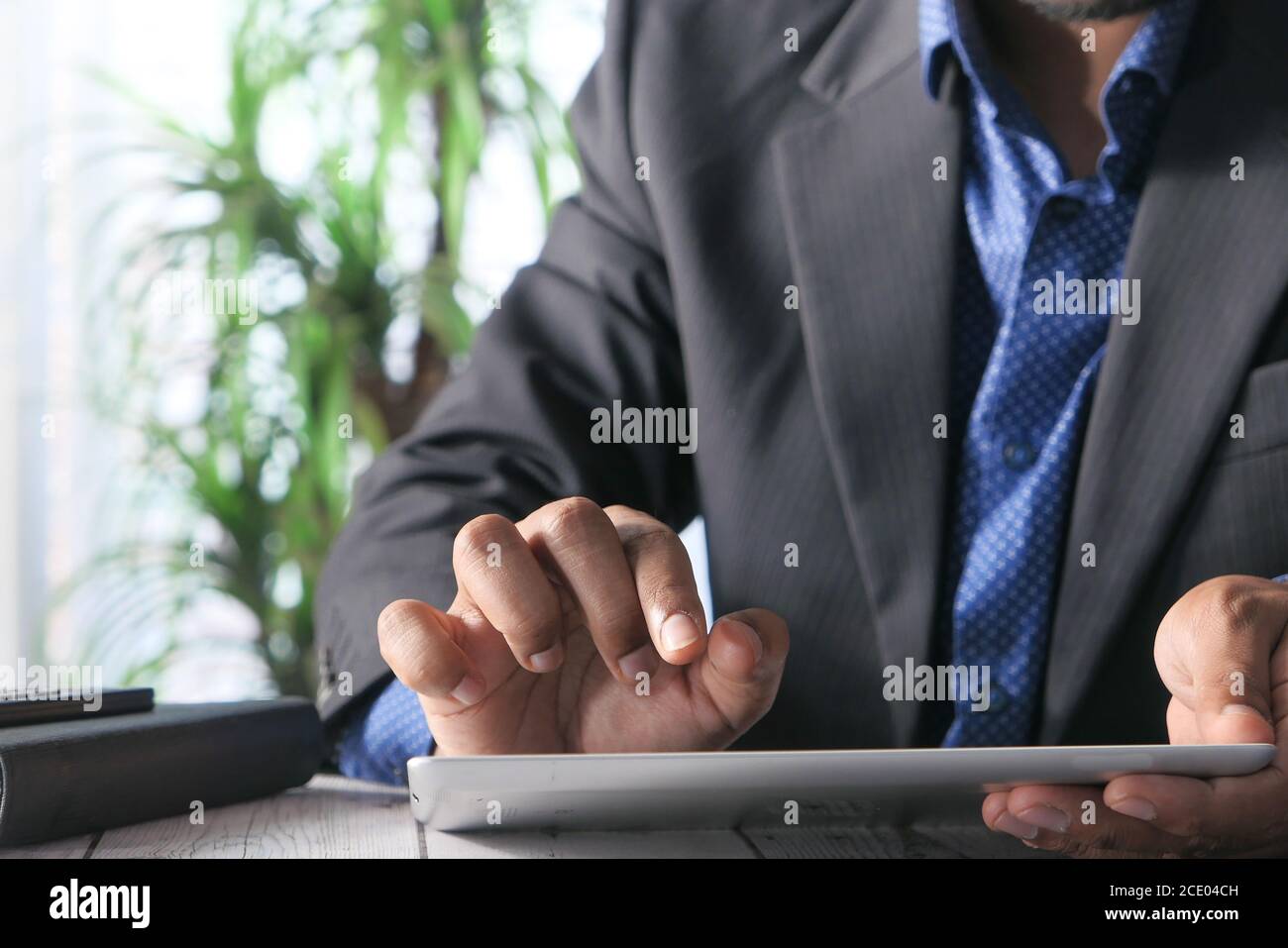 man's hand working on digital tablet at office desk, using self created ...