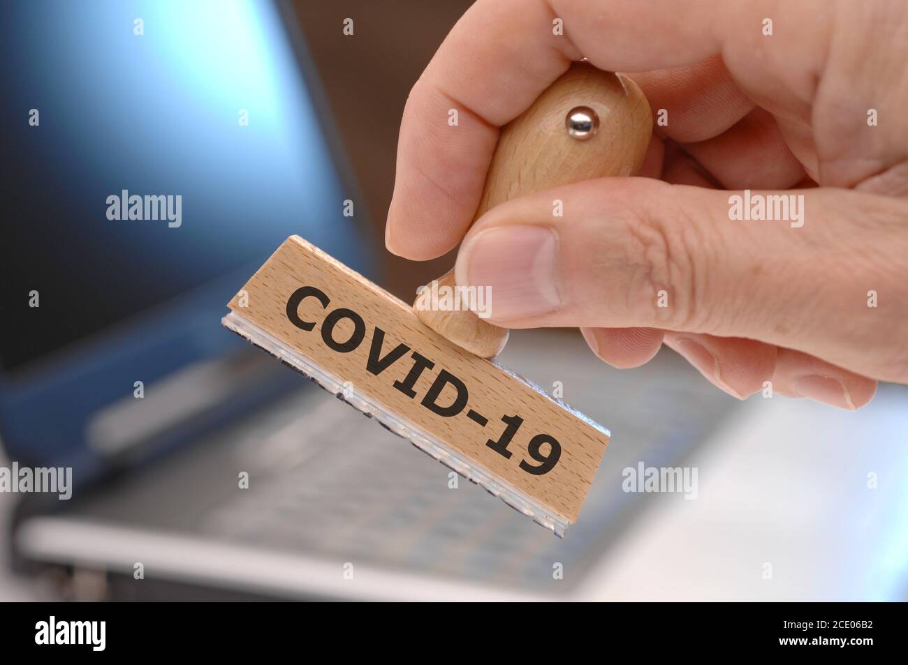 rubber stamp marked with covid-19 Stock Photo