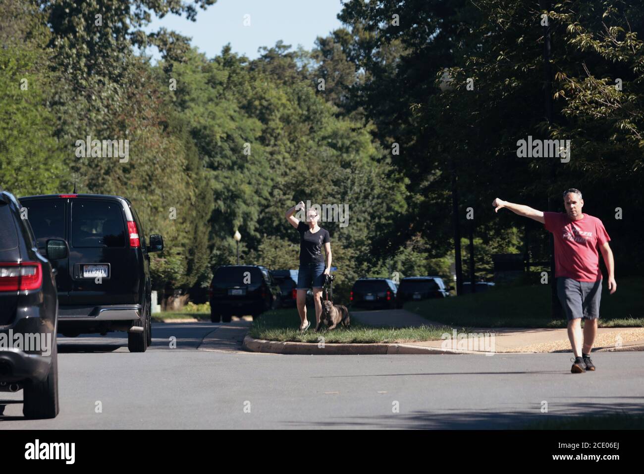 Protesters hold their thumbs down, as U.S. President Donald Trump's motorcade heads to his Trump National Golf Club, in Sterling, Virginia, U.S., August 30, 2020. REUTERS/Cheriss May Stock Photo