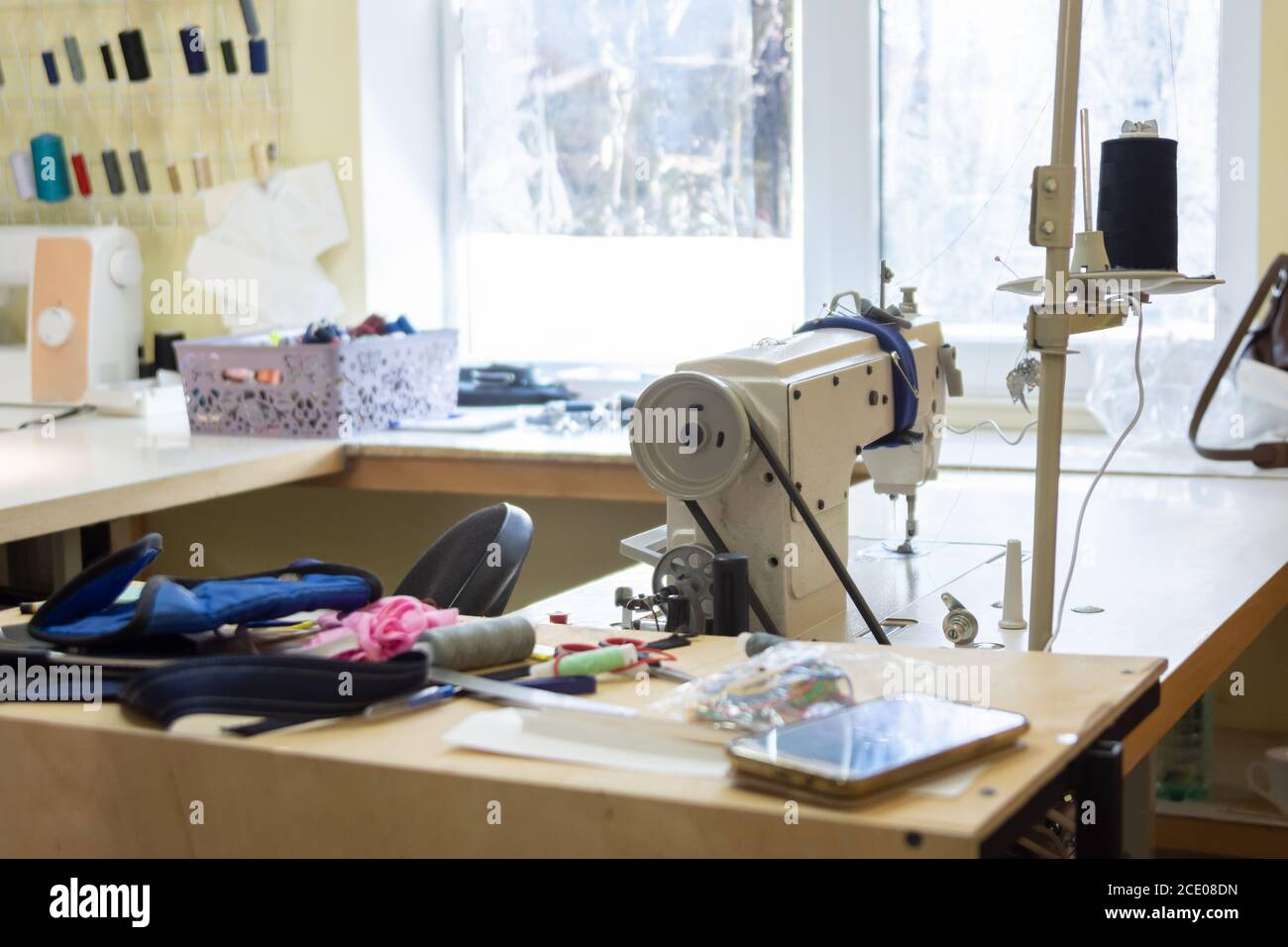 seamstresses in workshop with industrial sewing equipment Stock Photo