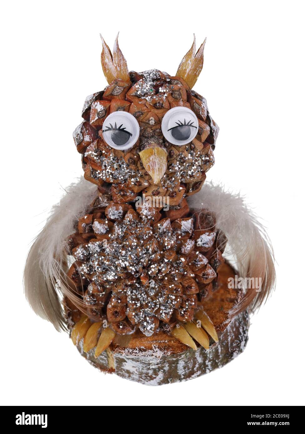 Guest homemade Christmas owl made of pine cone and feathers isolated macro Stock Photo