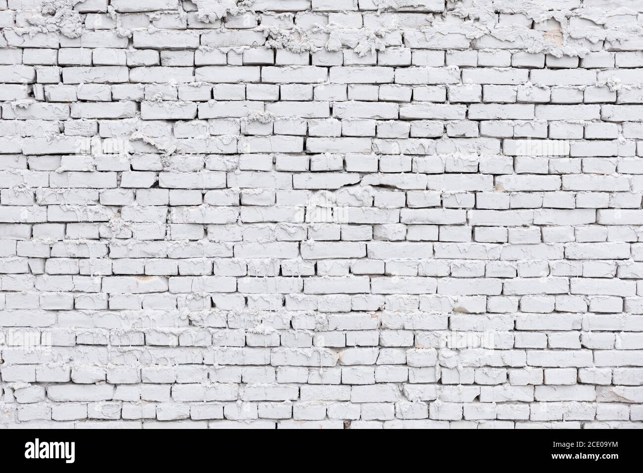 rough white brick wall with leaking plaster background Stock Photo